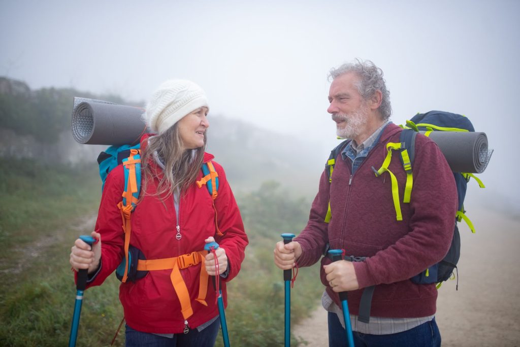 Senior couple hiking a mountain trail