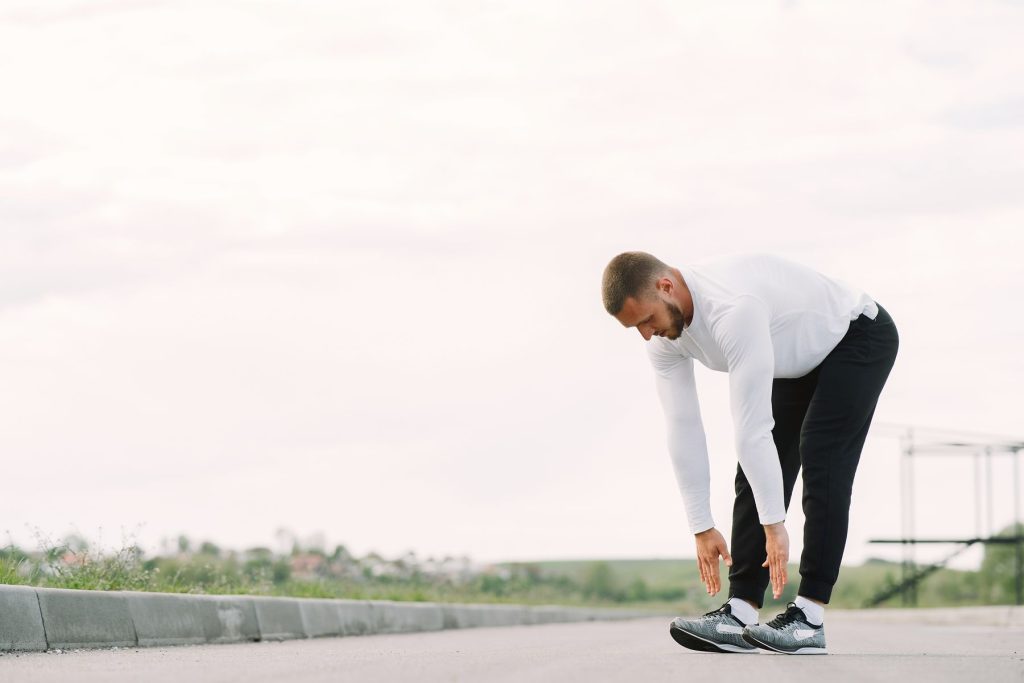 Man stretching outdoors in activewear