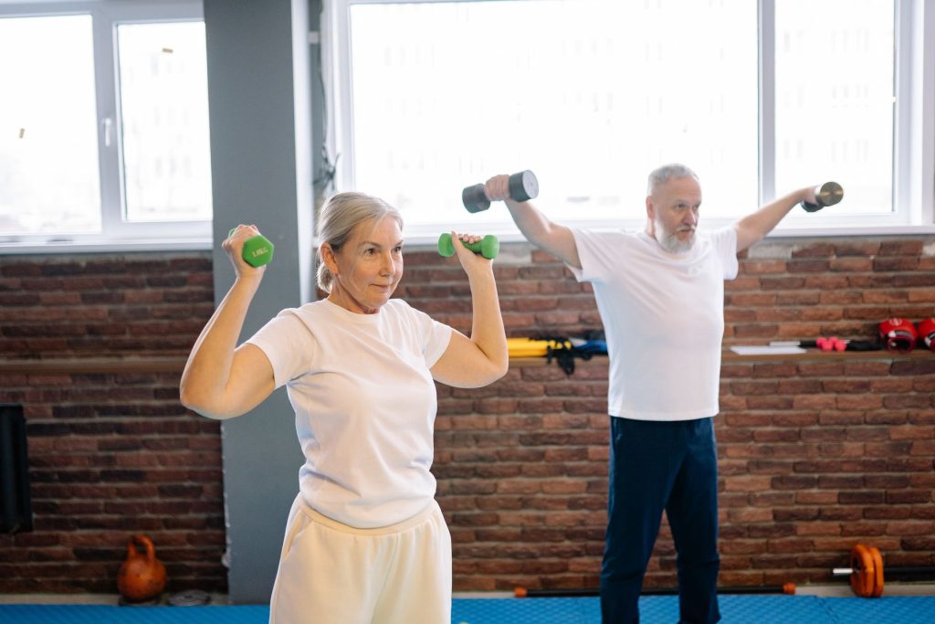 Older couple training with dumbbells